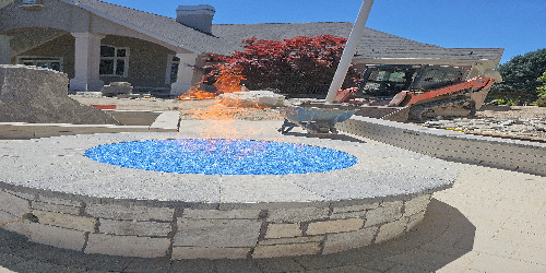 Rustic stone fire pit with built-in seating