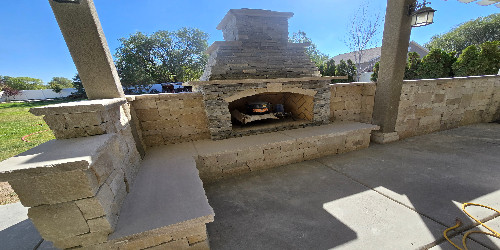 Built-in fire pit with a stone veneer